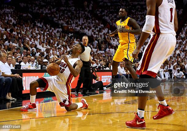 Norris Cole of the Miami Heat falls down after being hit in the face by Lance Stephenson of the Indiana Pacers during Game Six of the Eastern...