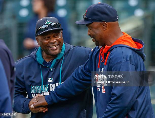 Manager Lloyd McClendon of the Seattle Mariners greets third base coach Dave Clark of the Detroit Tigers prior to the game at Safeco Field on May 30,...