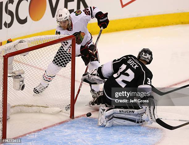 Ben Smith of the Chicago Blackhawks scores a goal off the skate of goaltender Jonathan Quick of the Los Angeles Kings in the second period in Game...