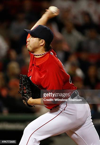 Junichi Tazawa of the Boston Red Sox pitches against the Tampa Bay Rays during the eighth inning of the game at Fenway Park on May 30, 2014 in...