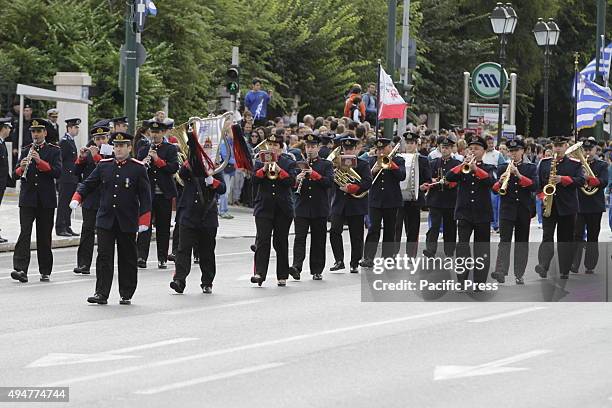 The Marching Band of the Hellenic Fire Service marches past the Greek Parliament and the review stands in the 'Oxi Day' parade in Athens. School...