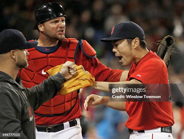 Pitcher Koji Uehara of the Boston Red Sox is congratulated by catchers David Ross and A.J. Pierzynski after retiring the Tampa Bay Rays in the ninth...