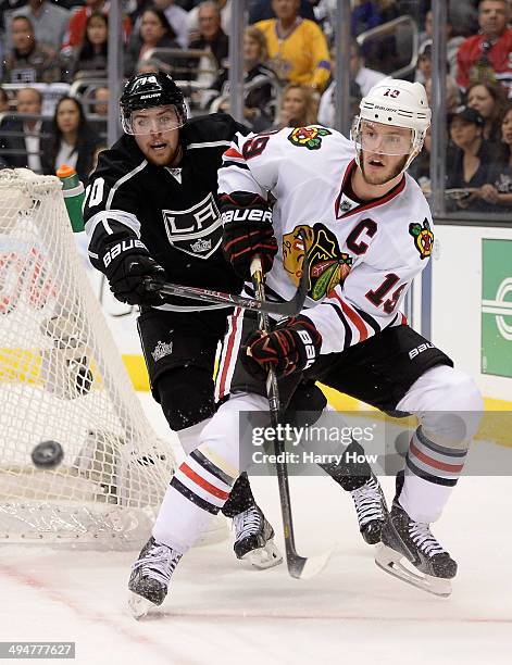 Jonathan Toews of the Chicago Blackhawks goes for the puck in front of Tanner Pearson of the Los Angeles Kings in the second period in Game Six of...