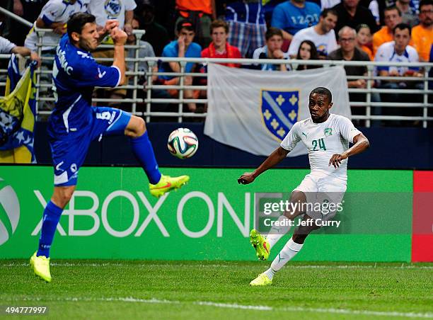 Jean-Daniel Akpa Akpro of the Ivory Coast shoots as Sead Kolasinac of the Bosnia-Herzegovina defends during the first half of a friendly match at...