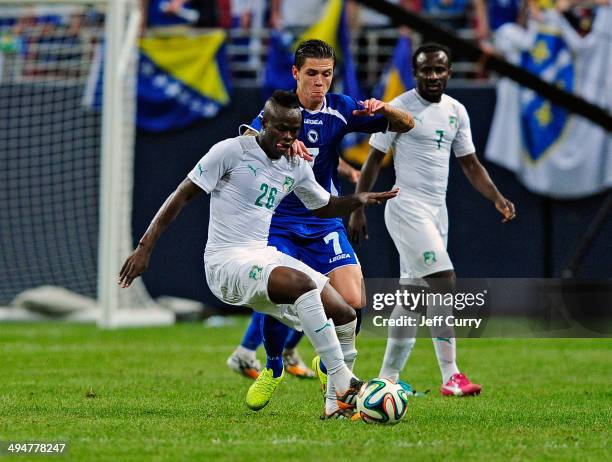 Ismael Diomande of the Ivory Coast handles the ball as Muhamed Besic of the Bosnia-Herzegovina defends during the second half of a friendly match at...