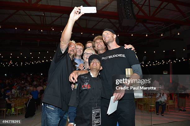 Chef Guy Fieri takes a picture with Michael Jaxtime-Barry, Tom Brady, John Hailer, Joe Kennedy, Joanne Jaxtimer and Anthony Shriver at the Tom Brady...