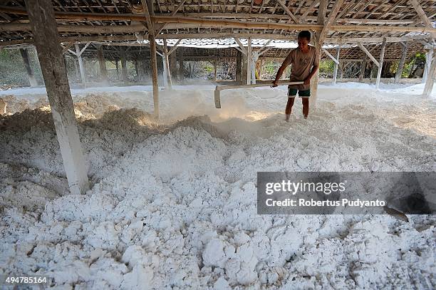 Limestone miner works during the refining process at Jaddih Hill, Bangkalan on October 29, 2015 in Madura, Indonesia. Limestone is used for brick...