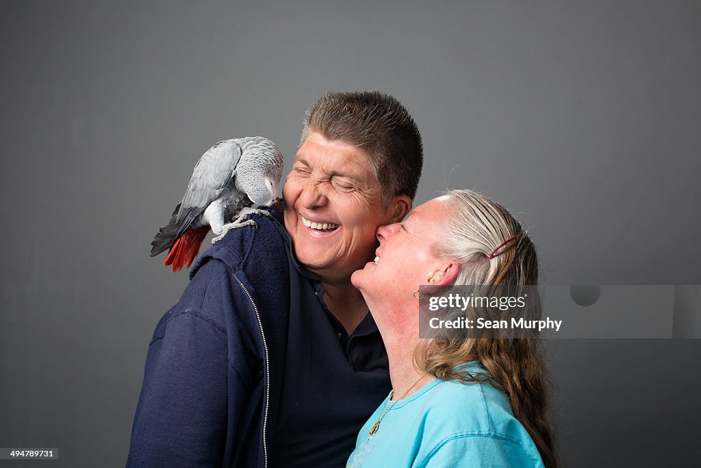 Couple with Grey Parrot