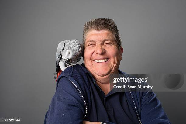 african grey parrot on man's shoulder - parrot shoulder stock pictures, royalty-free photos & images