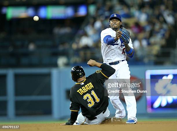 Shortstop Hanley Ramirez of the Los Angeles Dodgers throws to first to complete a double play after forcing out Jose Tabata of the Pittsburgh Pirates...