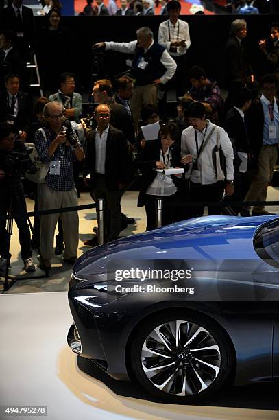 Attendees look at Toyota Motor Corp.'s Lexus LF-FC concept sedan on display at the Tokyo Motor Show in Tokyo, Japan, on Wednesday, Oct. 28, 2015....