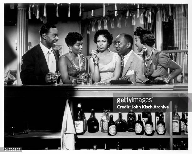 Publicity still of Dorothy Dandridge, Pearl Bailey, and Nick Stewart at the bar in the film 'Carmen Jones' , 1954.