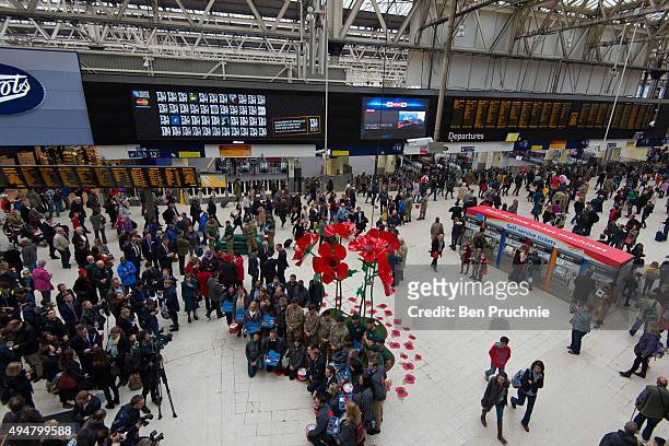 Remembrance sculpture made of 3 meter high poppies is unveiled at Waterloo Station during the launch of the British Royal Legion's London Poppy Day...