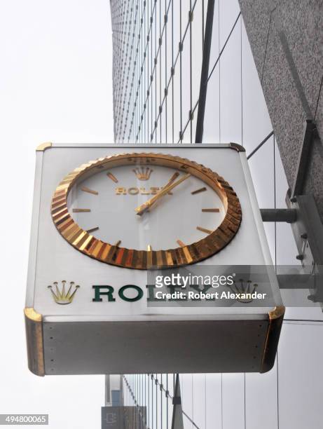 Clock hangs over the sidewalk entrance to a Rolex store in the Ginza district of Tokyo, Japan.