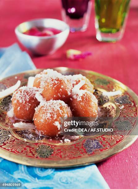 Gulab jamun, milk solid and flour dumplings soaked in a sugary syrup, India.