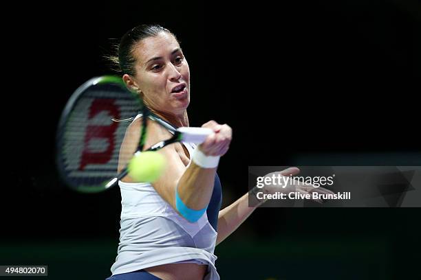 Flavia Pennetta of Italy in action against Maria Sharapova of Russia in a round robin match during the BNP Paribas WTA Finals at Singapore Sports Hub...