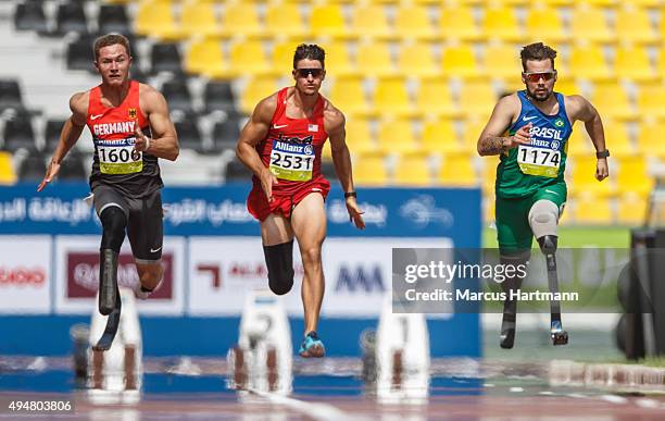 Felix Streng of Germany, Trenten Merrill of the United States and Alan Oliveira Cardoso Oliveira of Brasil competing in the men's 100m T44 heats...