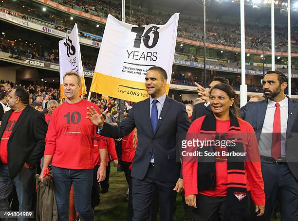 Michael O'Loughlin, Nova Peris, Adam Goodes and Michael Long take part in The Long Walk to Dreamtime at the 'G during the round 11 AFL match between...