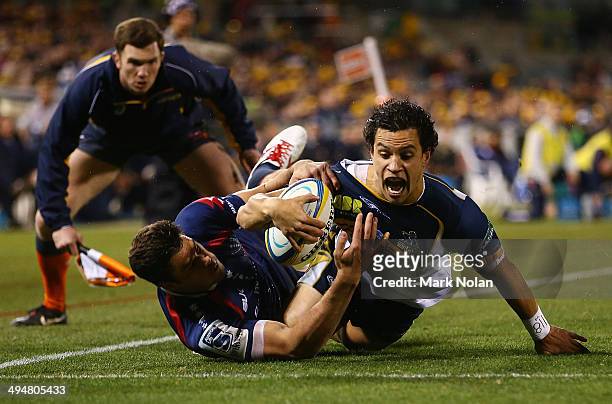 Matt Toomua of the Brumbies scores a try during the round 16 Super Rugby match between the Brumbies and the Rebels at Canberra Stadium on May 31,...