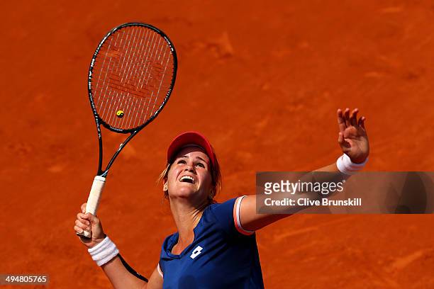 Maria Teresa Torro Flor of Spain serves during her women's singles match against Simona Halep of Romania on day seven of the French Open at Roland...