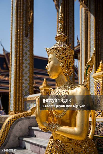 Gold sculpture Kinnara dancer in Royal palace, Bangkok, Thailand.