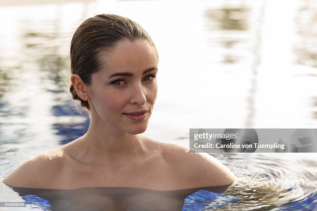 Beauty portrait of young woman in pool