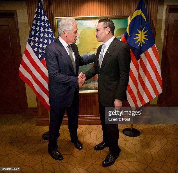 Defense Secretary Chuck Hagel, left, meets with Malaysian Defense Minister Hishammuddin Hussein on May 31, 2014 in Singapore. Hagel warned an...