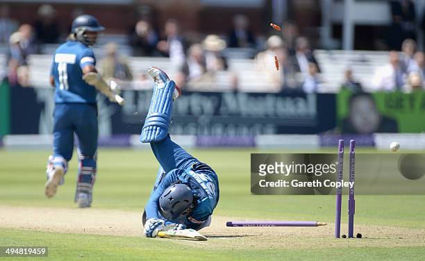 Tillakaratne Dilshan of Sri Lanka dives to make his ground as England captain Alastair Cook's throw hits the stumps during the 4th Royal London One...