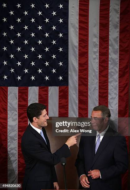 Incoming Speaker of the House Rep. Paul Ryan points at outgoing U.S. Speaker of the House Rep. John Boehner in the House Chamber of the Capitol...