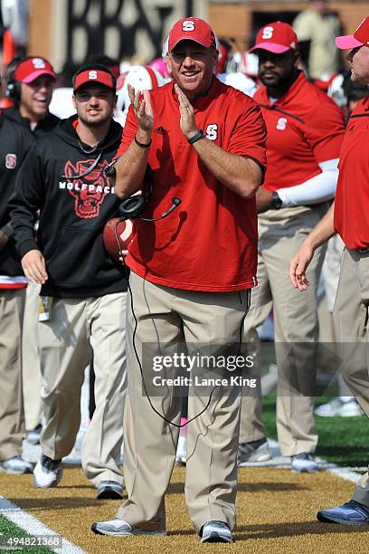 Head Coach Dave Doeren of the North Carolina State Wolfpack celebrates from the sideline during their game against the Wake Forest Demon Deacons at...