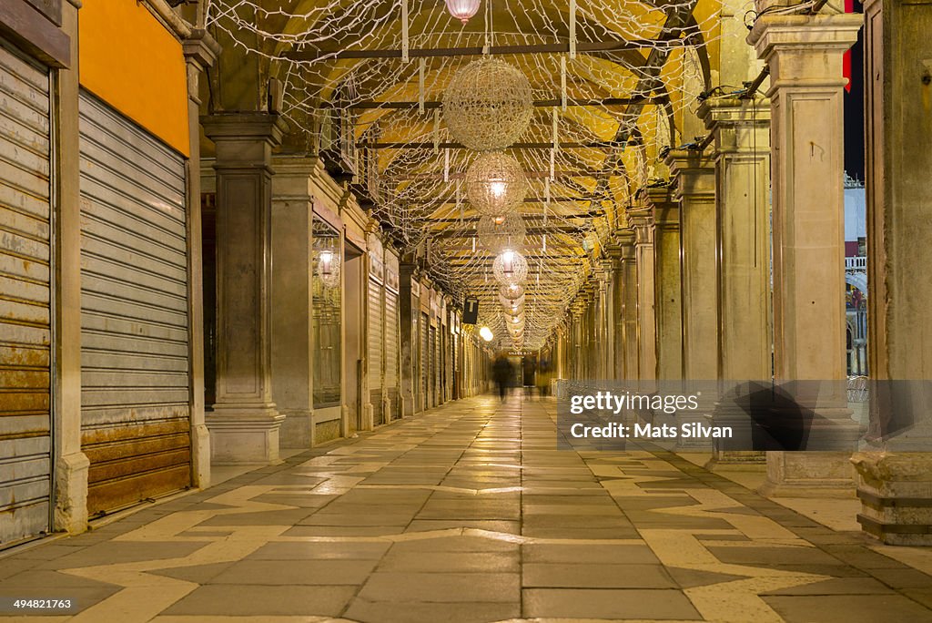 People walking under an archway