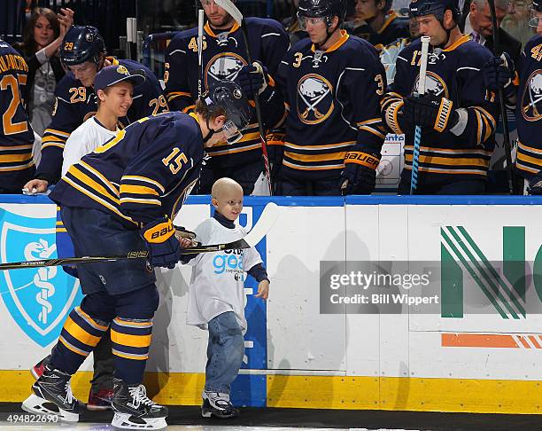 Carly's Club member Matthew Eggers is escorted on the ice by Jack Eichel of the Buffalo Sabres prior to their NHL game against the New Jersey Devils...