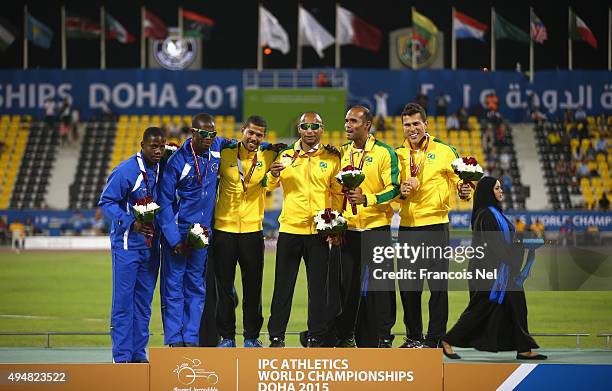 Felipe Gomes of Brazil poses with his gold medal, Ananias Shikongo of Namibia silver and Daniel Silva of Brazil bronze for the men's 200m T11 final...