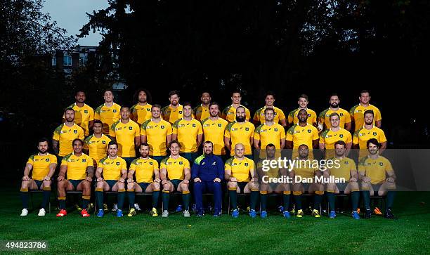 The Australia squad pose for a group photo with Michael Cheika, Head Coach of Australia during an Australia media session at The Lensbury Hotel on...