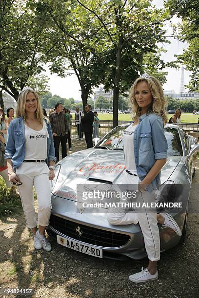 Slovak model Adriana Sklenarikova , formerly known as Adriana Karembeu, and her sister Natalia Sklenarikova , pose with her Ferrari California prior...