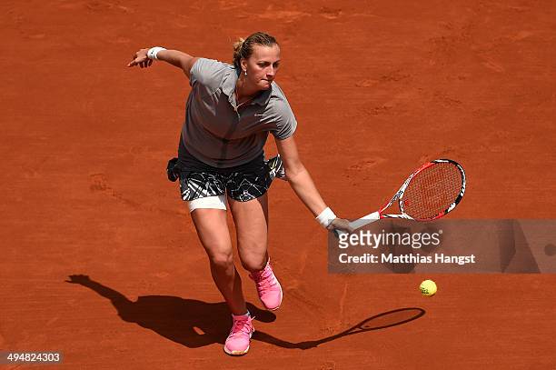 Petra Kvitova of Czech Republic returns a shot during her women's singles match against Svetlana Kuznetsova of Russia on day seven of the French Open...