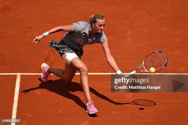 Petra Kvitova of Czech Republic returns a shot during her women's singles match against Svetlana Kuznetsova of Russia on day seven of the French Open...