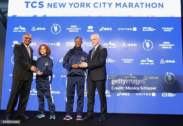 Surya Kant, President of TCS North American, UK and Europe, Youth Running Ambassadors AniÕa Campbell and Jiovanni Olivero, and NYRR President & CEO,...