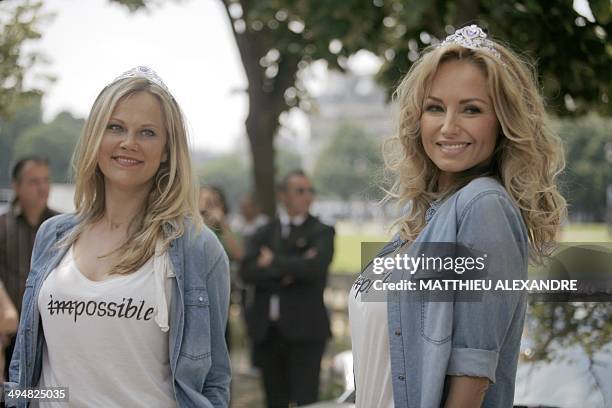 Slovak model Adriana Sklenarikova , formerly known as Adriana Karembeu, and her sister Natalia Sklenarikova, pose prior to the departure of the 15th...