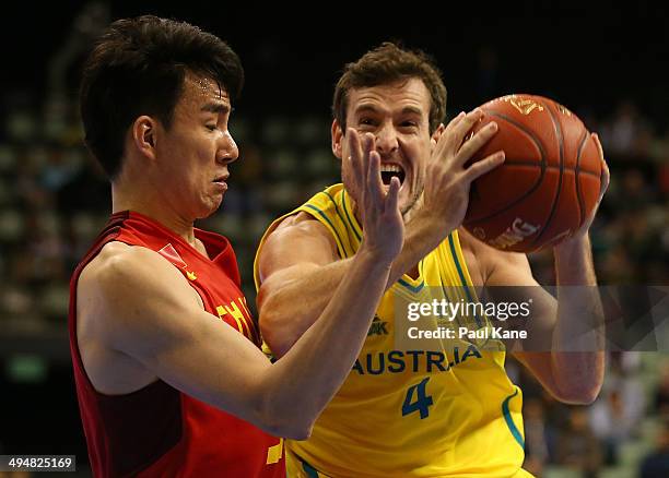 Ben Madgen of Australia drives to the basket against Fei Cao of China during the 2014 Sino-Australia Challenge match between the Australian Boomers...