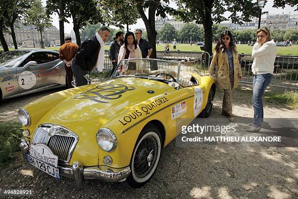 People look at an MG vintage car prior to the departure of the 15th edition of the "Rallye des Princesses" on May 31, 2014 in Paris. The Rallye des...