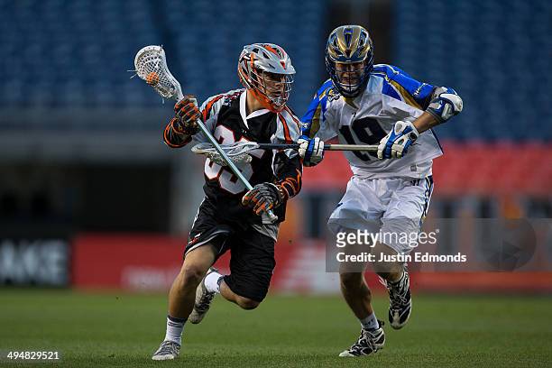 Jeremy Noble of the Denver Outlaws in action against Kevin Drew Charlotte Hounds at Sports Authority at Mile High on May 30, 2014 in Denver,...
