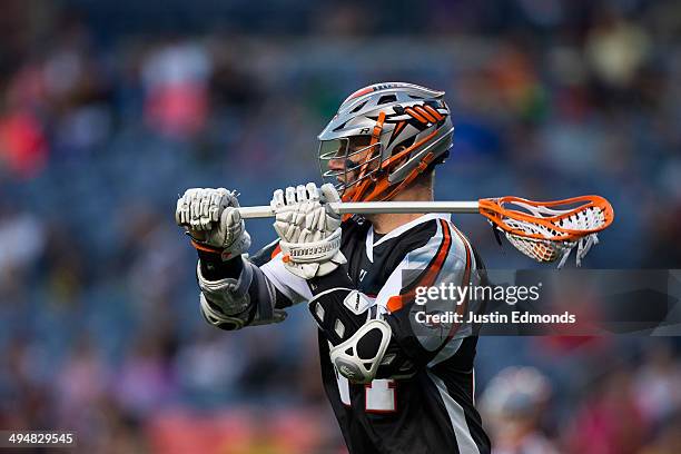 John Grant Jr. #24 of the Denver Outlaws in action against the Charlotte Hounds at Sports Authority Field at Mile High on May 30, 2014 in Denver,...