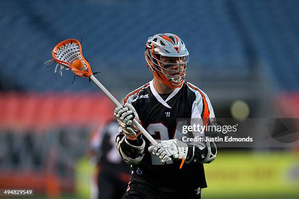 John Grant Jr. #24 of the Denver Outlaws in action against the Charlotte Hounds at Sports Authority Field at Mile High on May 30, 2014 in Denver,...