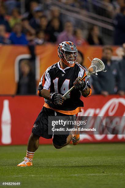 Justin Pennington of the Denver Outlaws in action against the Charlotte Hounds at Sports Authority Field at Mile High on May 30, 2014 in Denver,...