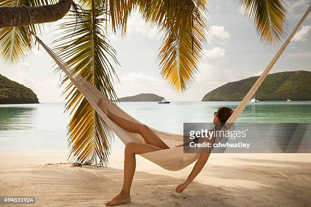 woman relaxing in hammock at maho bay beach, st.john, usvi - us virgin islands stock pictures, royalty-free photos & images