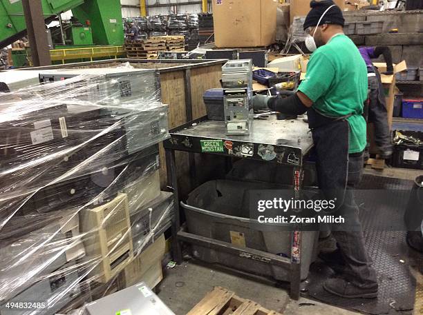 An employee dismantles a computer as electronic recyclable waste at the Electronic Recyclers International plant in Holliston, Massachusetts, USA.