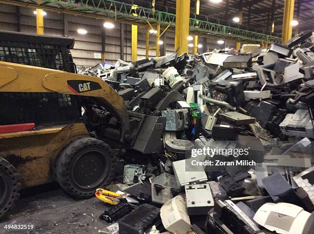 Forklift grabs electronic waste awaiting to be dismantles as electronic recyclable waste at the Electronic Recyclers International plant in...