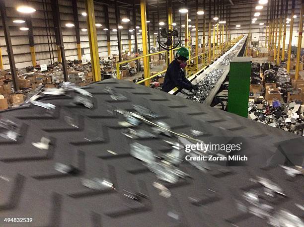 Crushed in small metal parts dismantled and on a conveyer belt as electronic recyclable waste at the Electronic Recyclers International plant in...