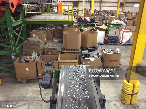 Crushed in small metal parts dismantled and on a conveyer belt as electronic recyclable waste at the Electronic Recyclers International plant in...